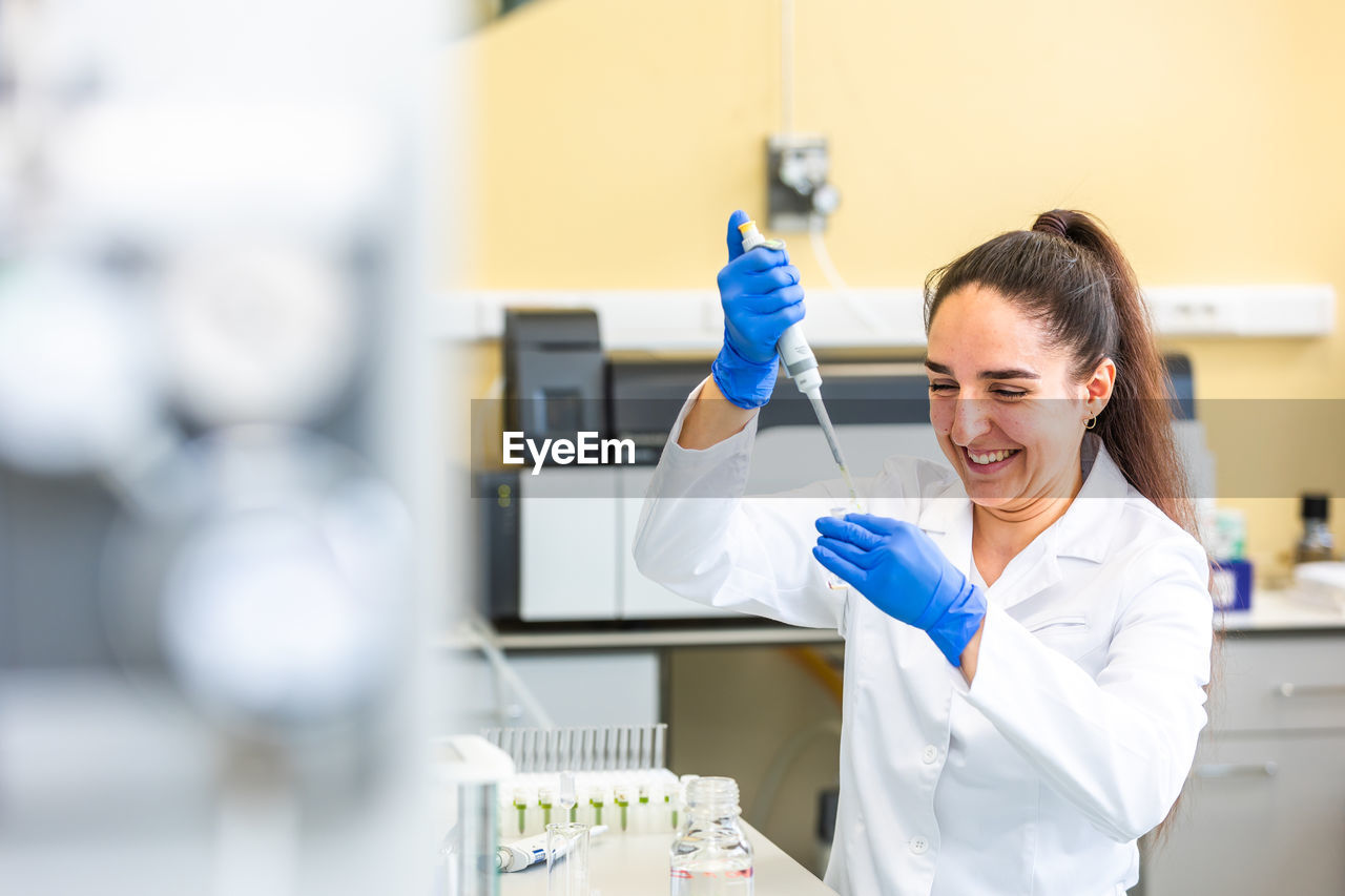 portrait of scientist holding syringe in laboratory