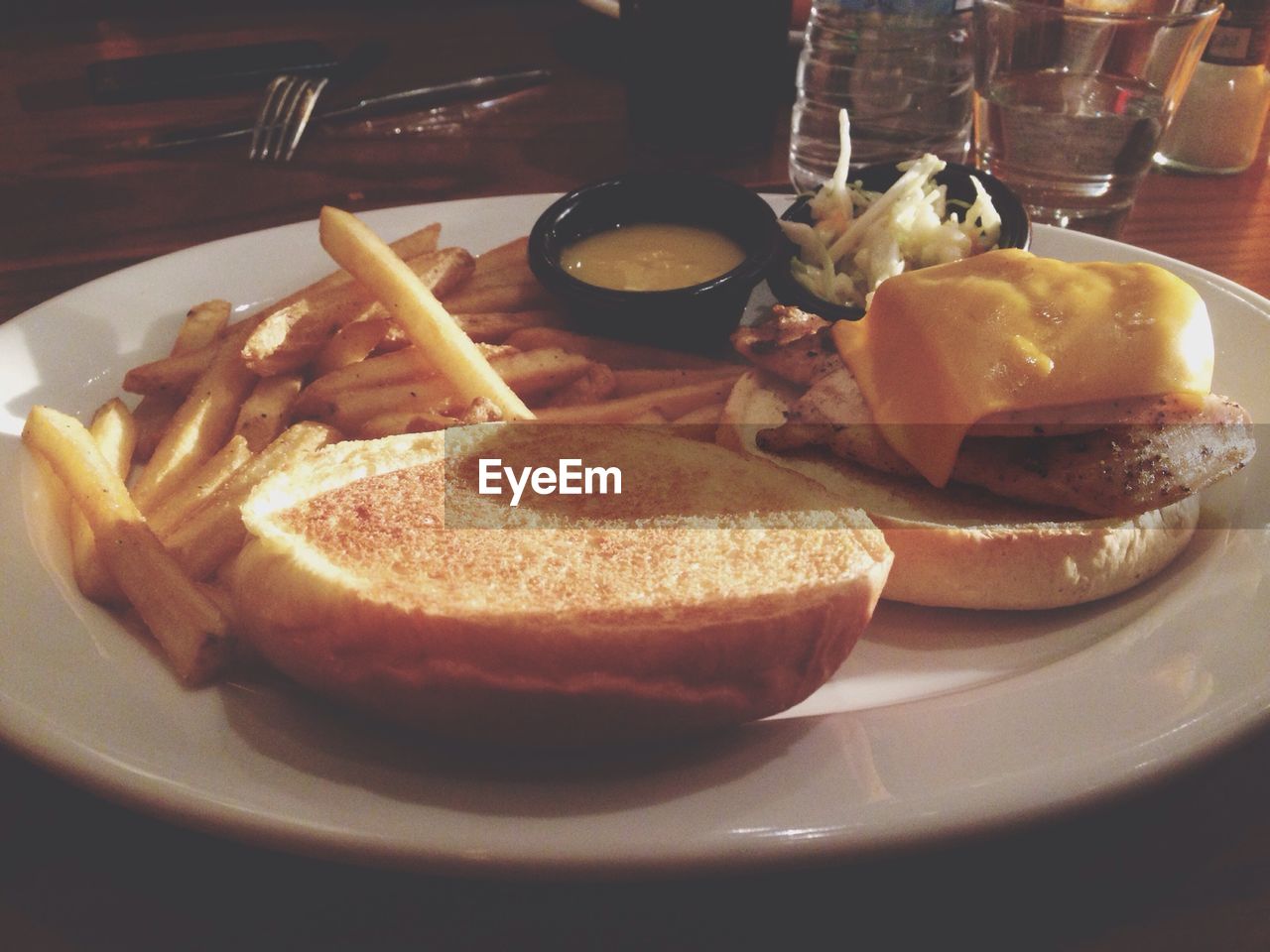 Close-up of served burger with french fries in plate