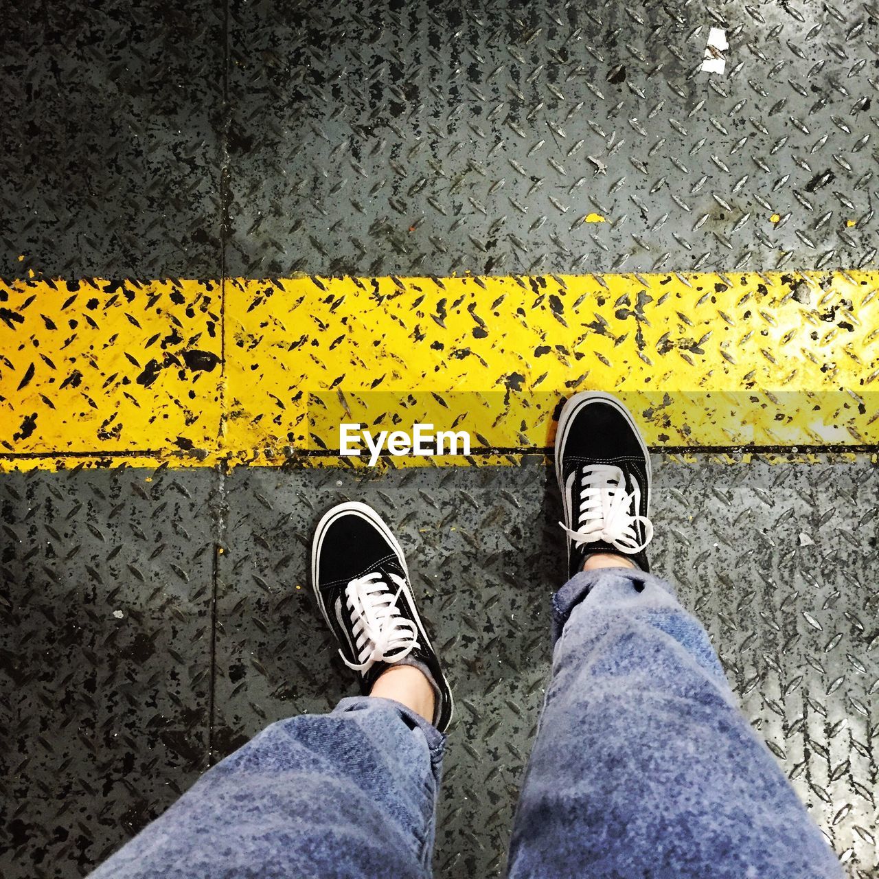 Low section of person standing on sheet metal