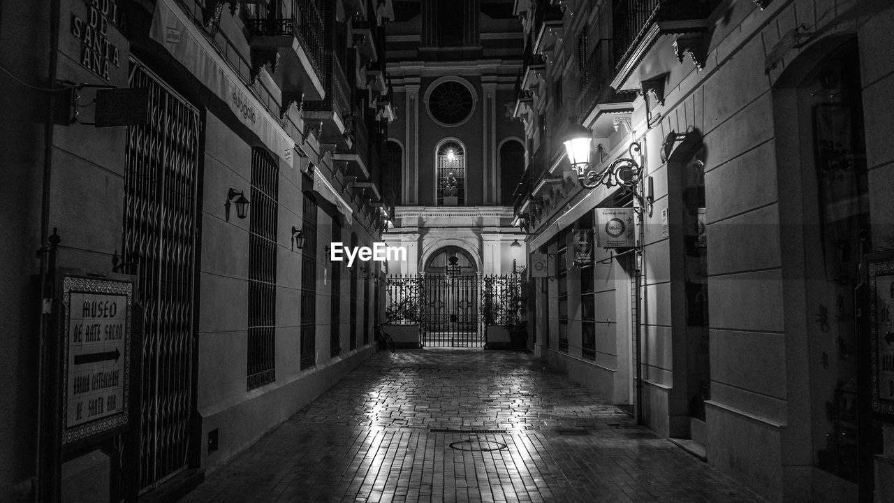 INTERIOR OF EMPTY CORRIDOR ALONG BUILDINGS