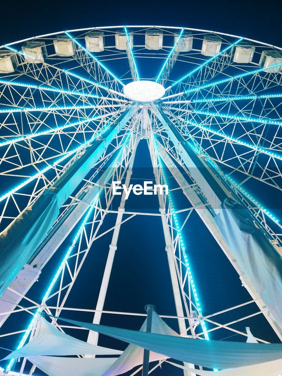LOW ANGLE VIEW OF FERRIS WHEEL AGAINST BLUE SKY