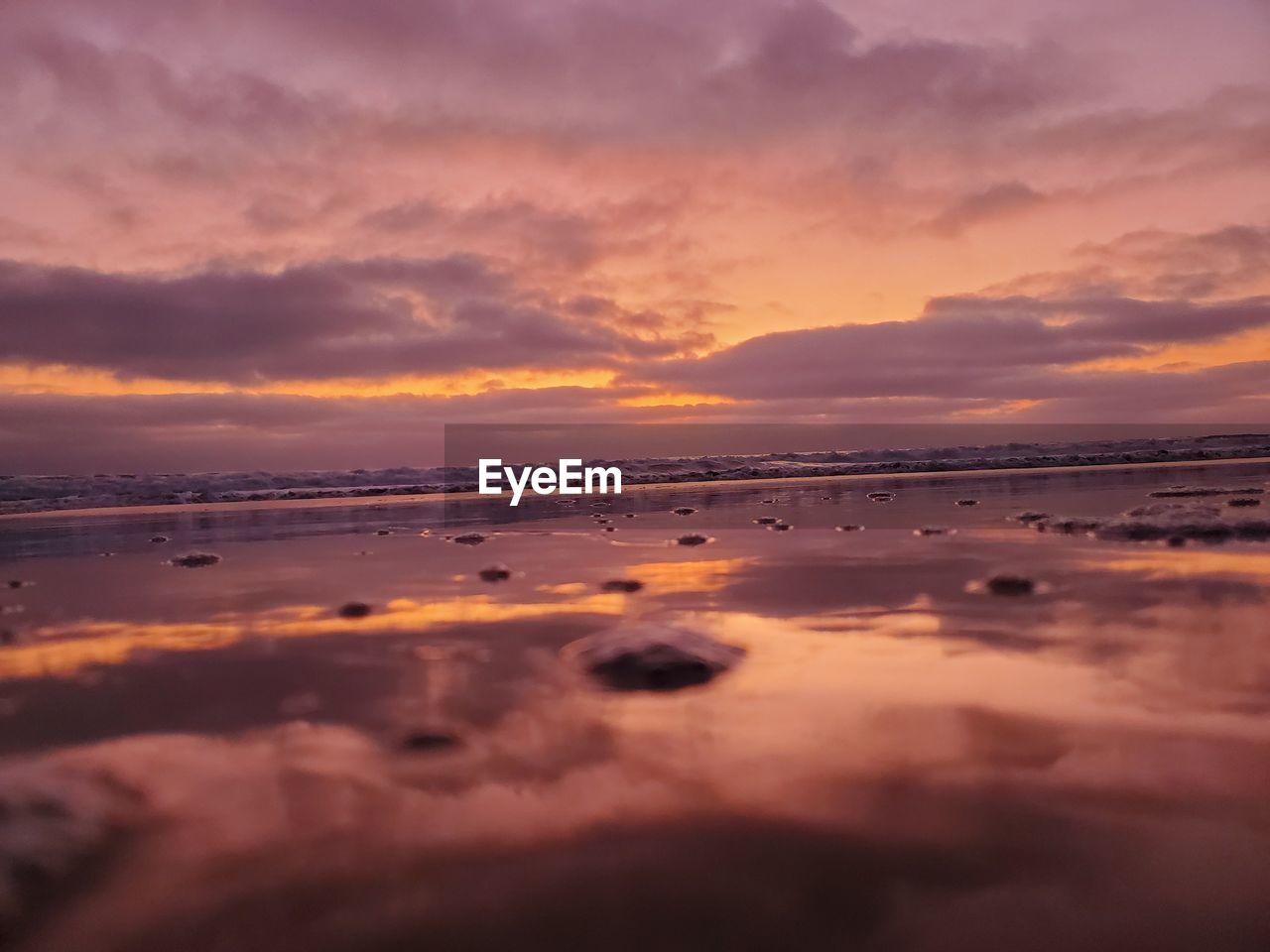 SCENIC VIEW OF BEACH DURING SUNSET