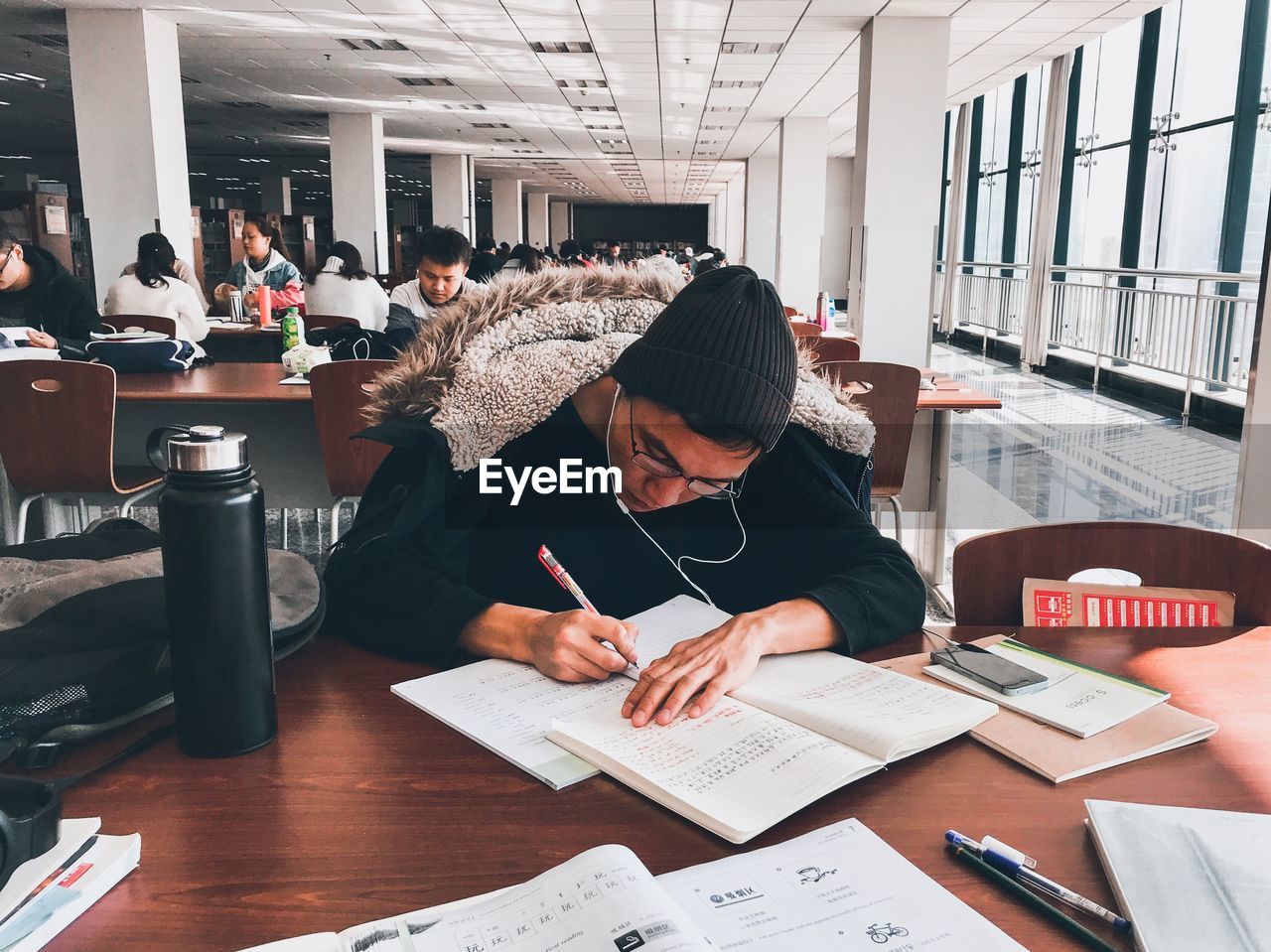 PEOPLE WORKING ON BOOK WITH TABLE