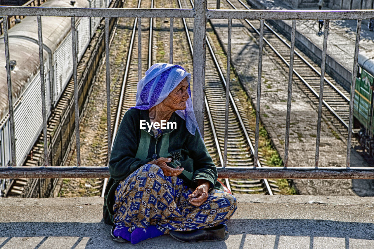 WOMAN SITTING ON STAIRCASE