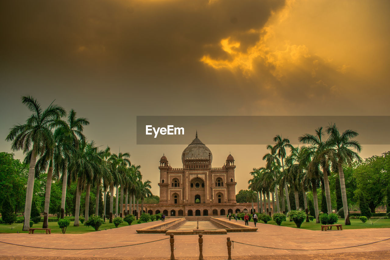 Historic building against cloudy sky at sunset