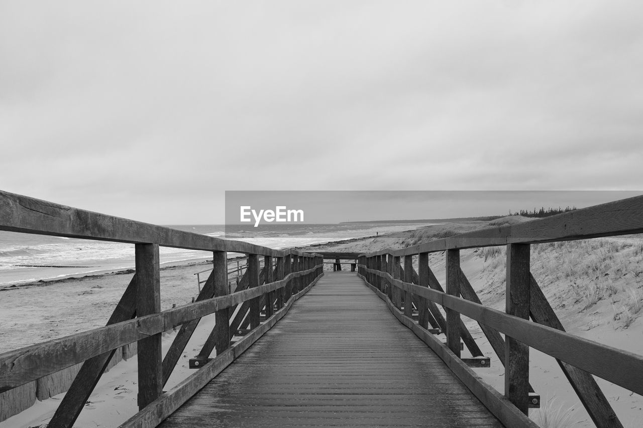 Pier over sea against sky