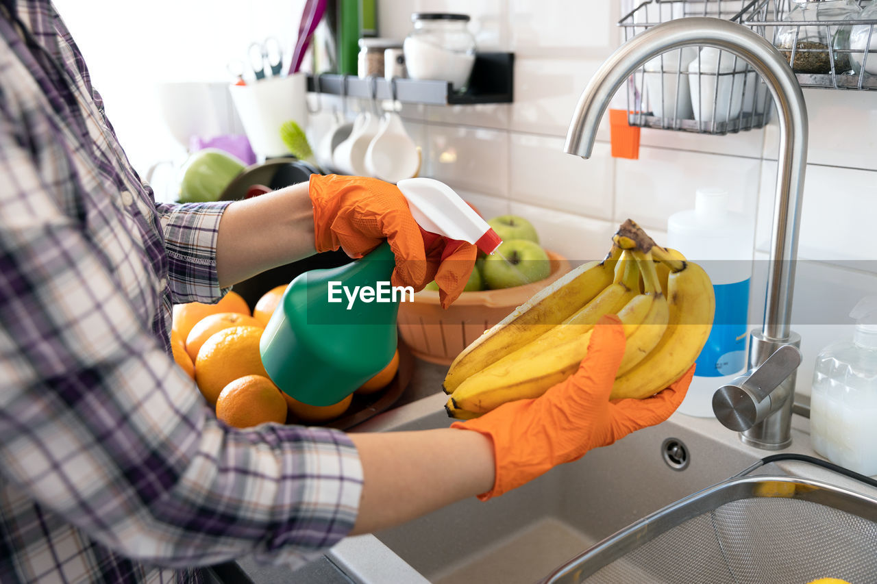 Spraying disinfecting chemical on the fruit in the kitchen