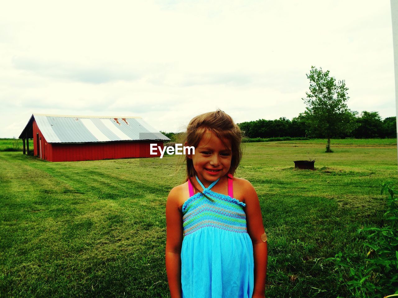 Happy girl enjoying on grassy field