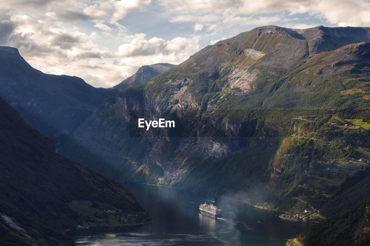 High angle view of ship moving from fjord on sea