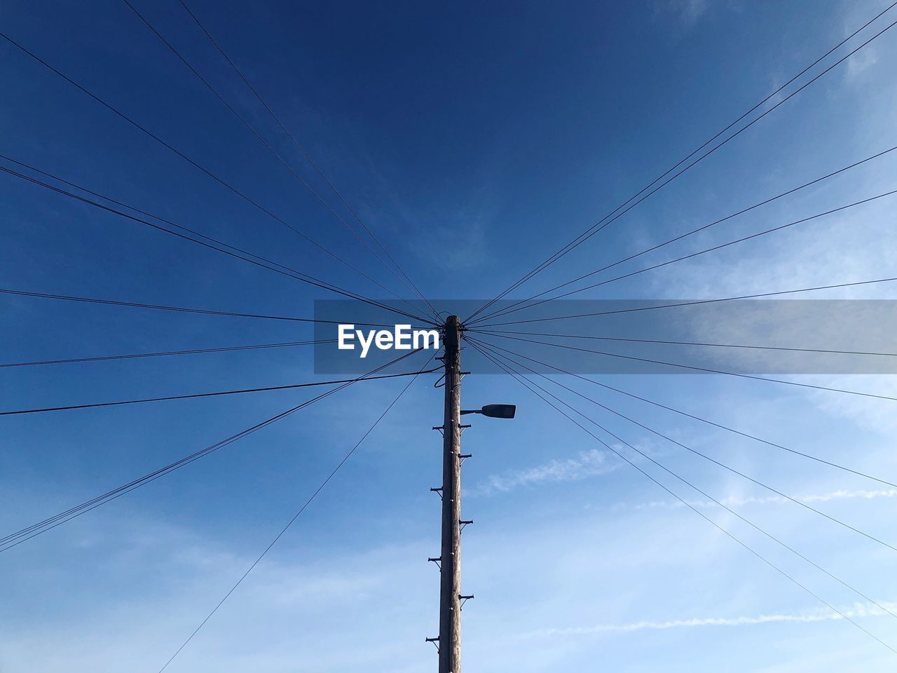 LOW ANGLE VIEW OF POWER LINES AGAINST BLUE SKY