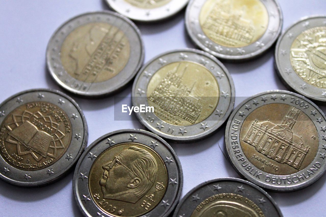 CLOSE-UP OF COINS ON METAL