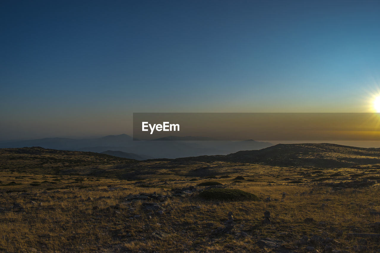 Scenic view of landscape against sky during sunset