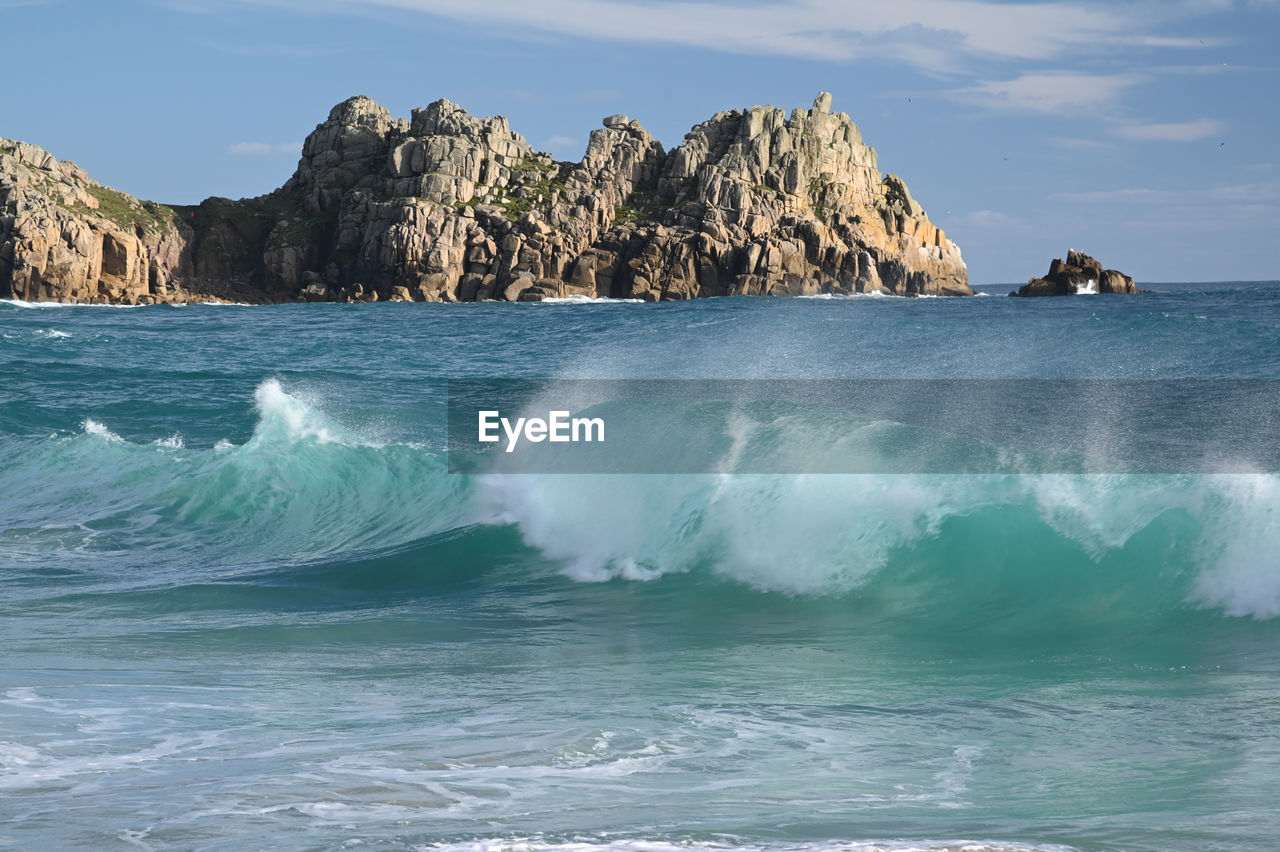 SCENIC VIEW OF SEA AGAINST ROCK FORMATION