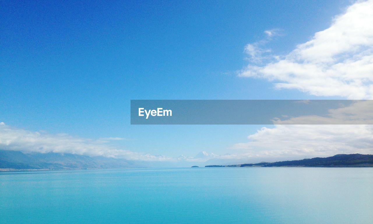 Scenic shot of calm sea against cloudy sky