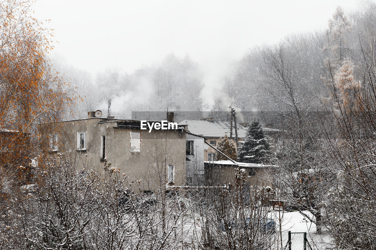 HOUSES AGAINST SKY DURING WINTER