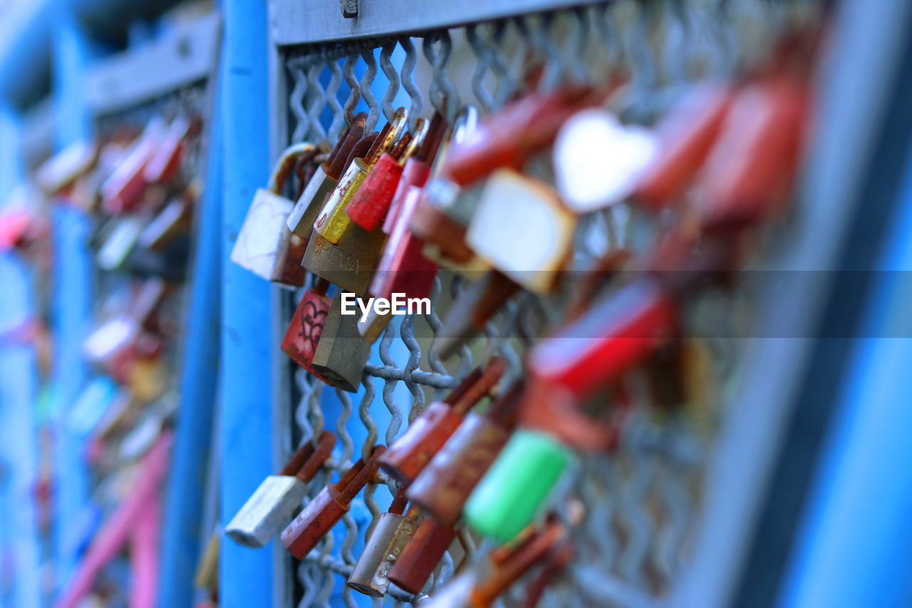 Close-up of padlocks on railing