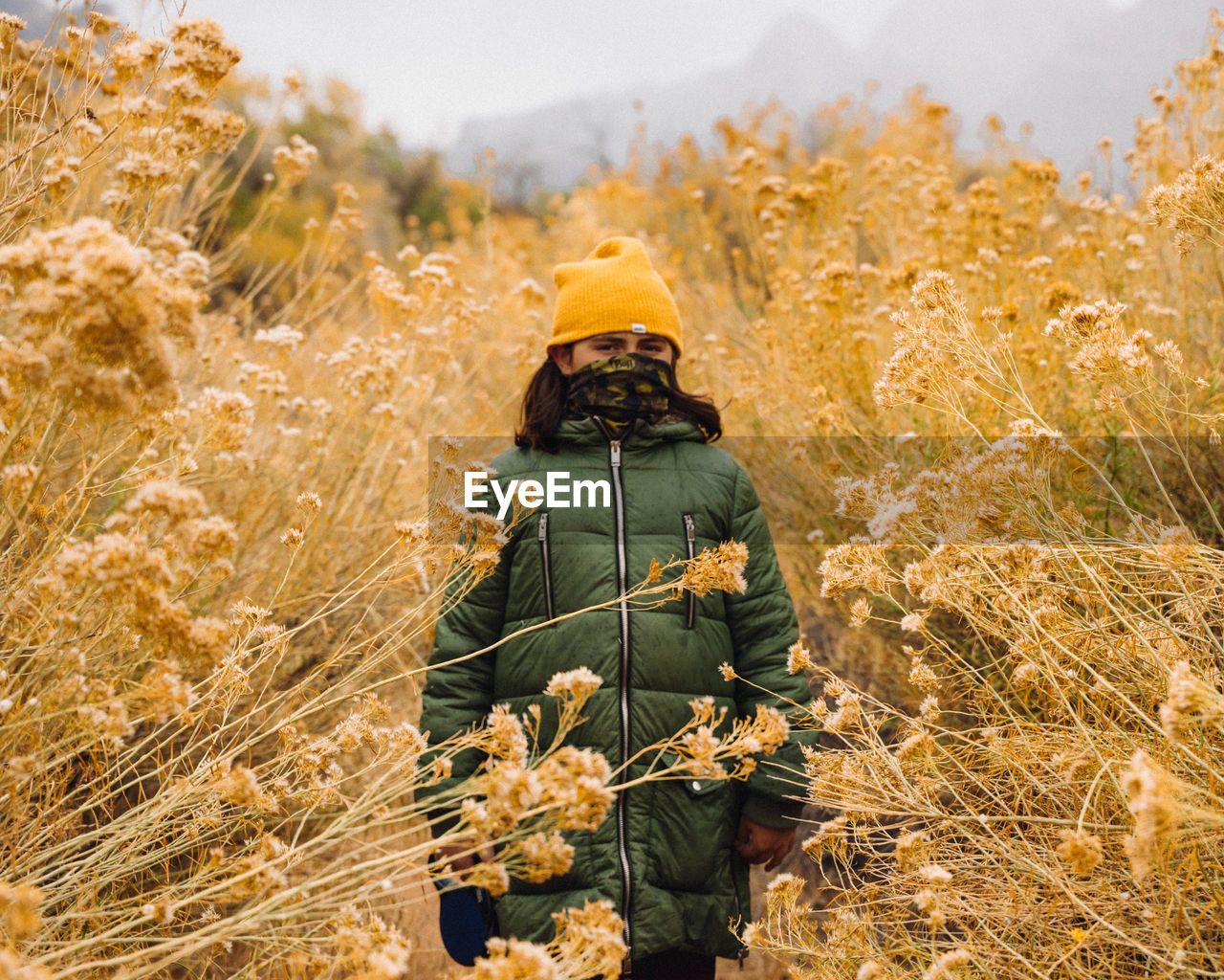 Man photographing plants on field