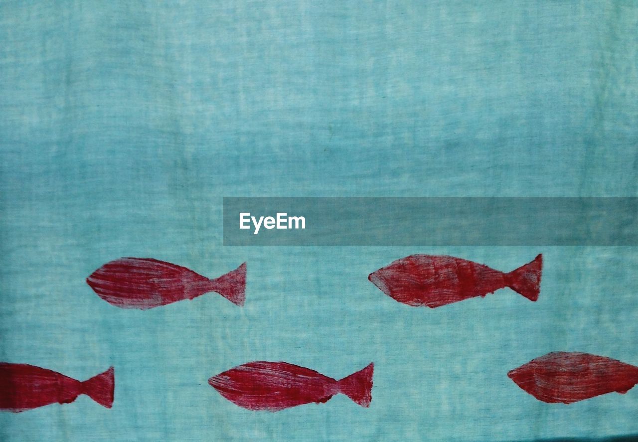 Close-up of fish pattern on curtain