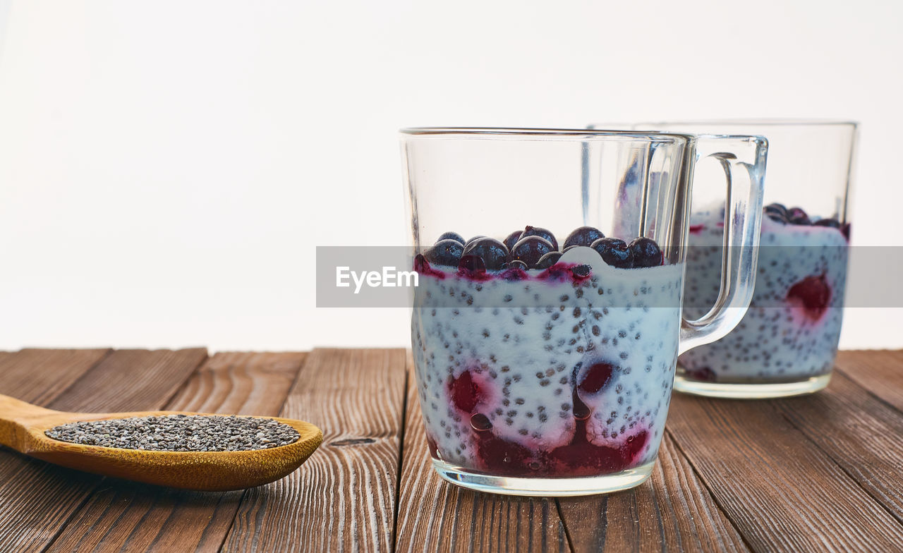 CLOSE-UP OF ICE CREAM ON WOODEN TABLE