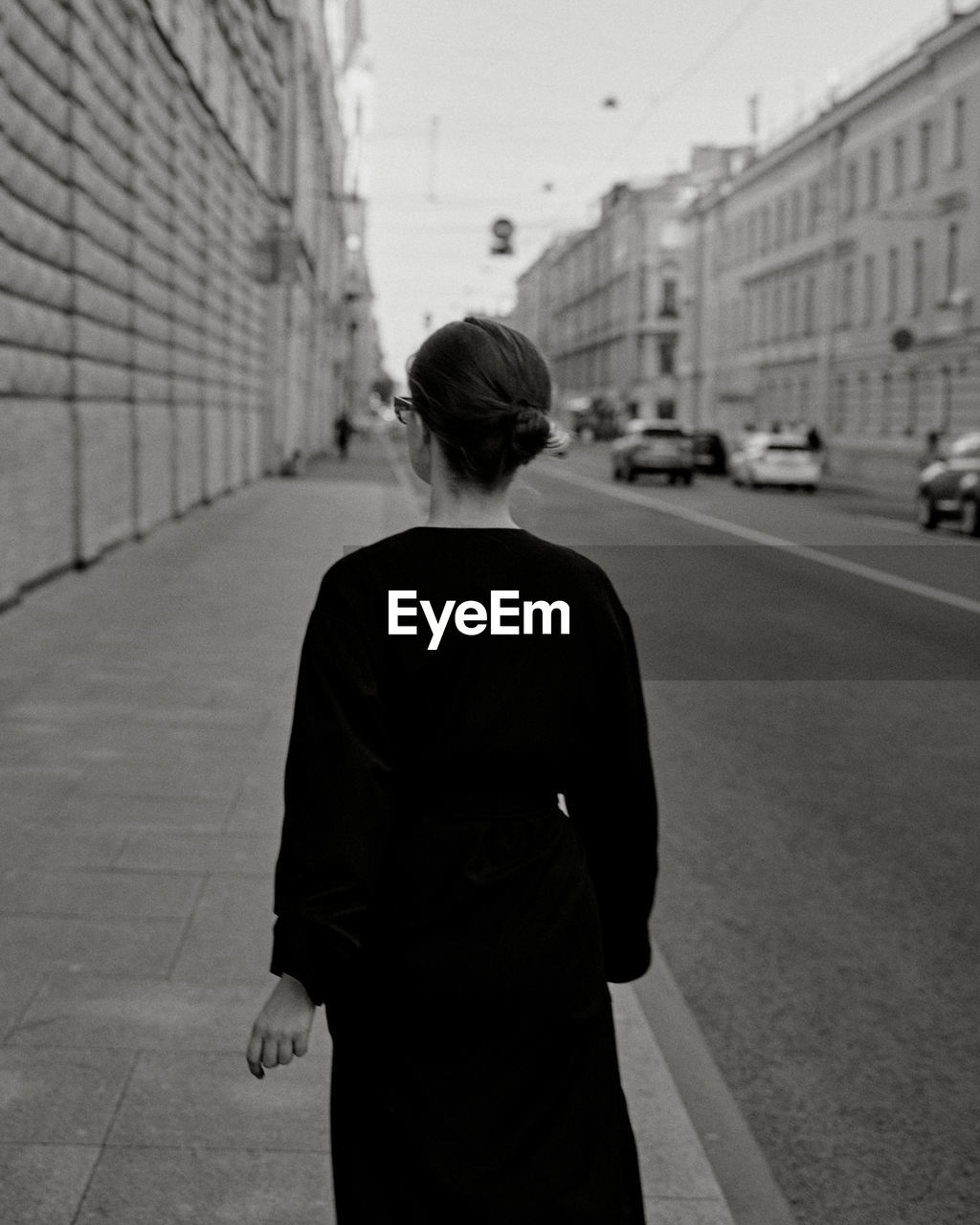 Rear view of woman walking on street