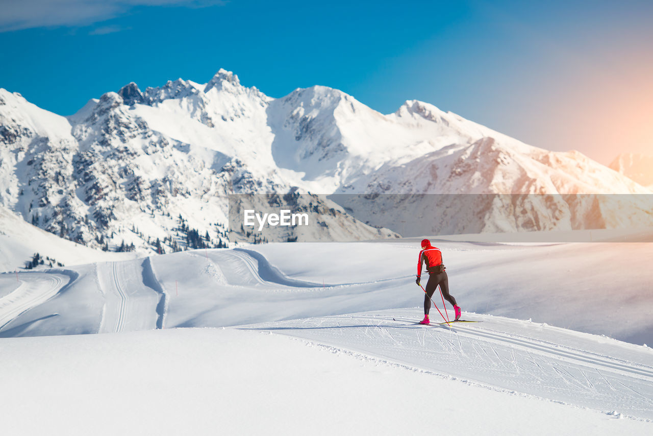 Cross-country skiing classic technique practiced by man in a beautiful panoramic trail