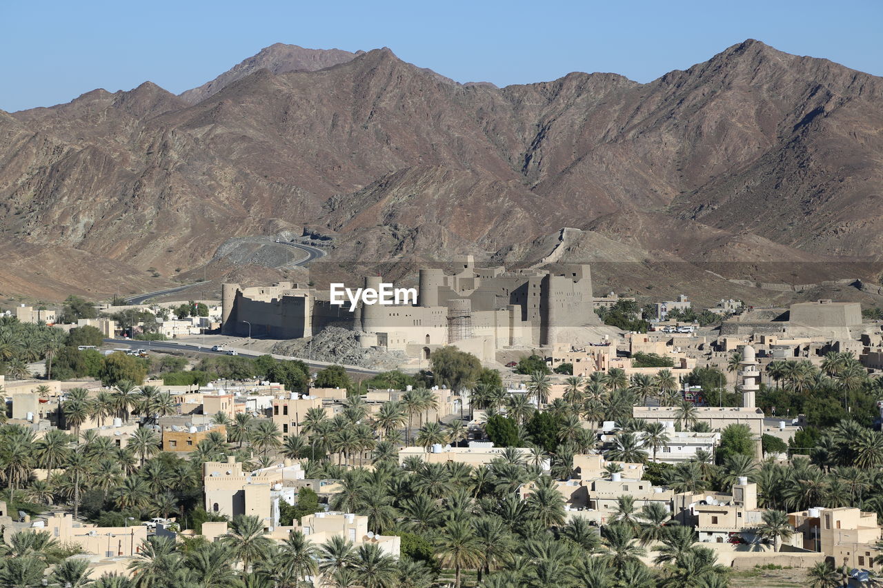 Buildings in city against clear sky