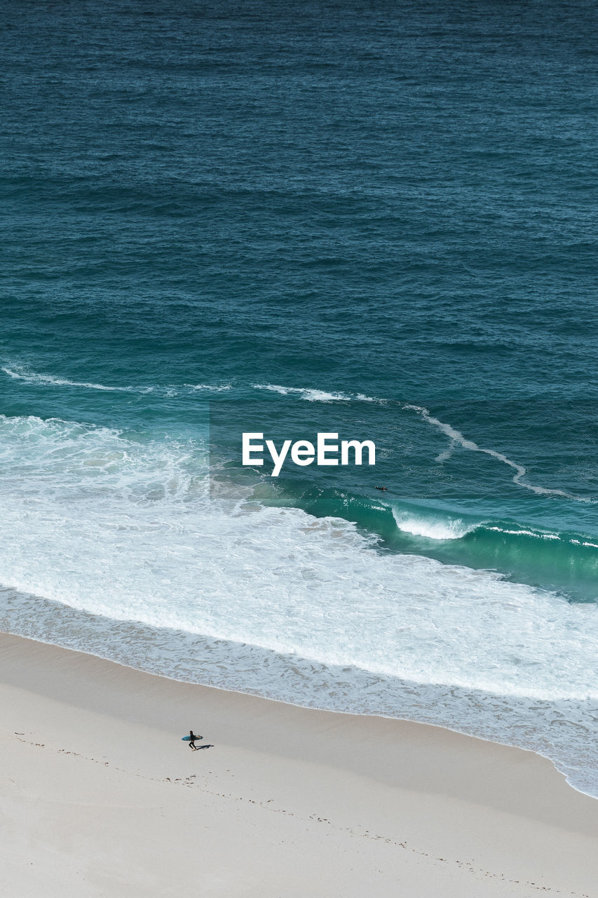 Aerial view of surfer on beach