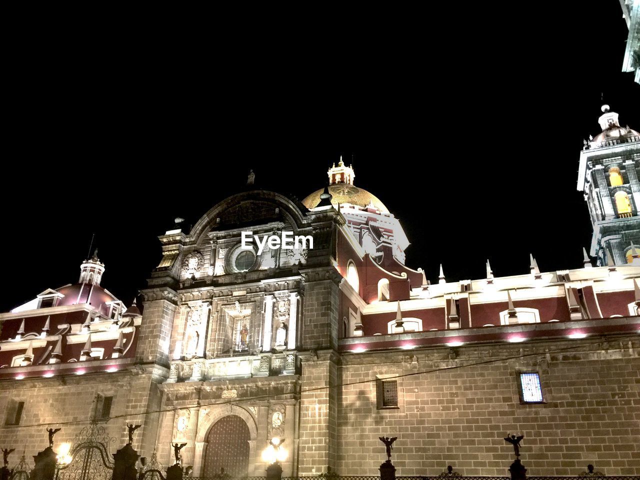 Low angle view of illuminated puebla cathedral at night