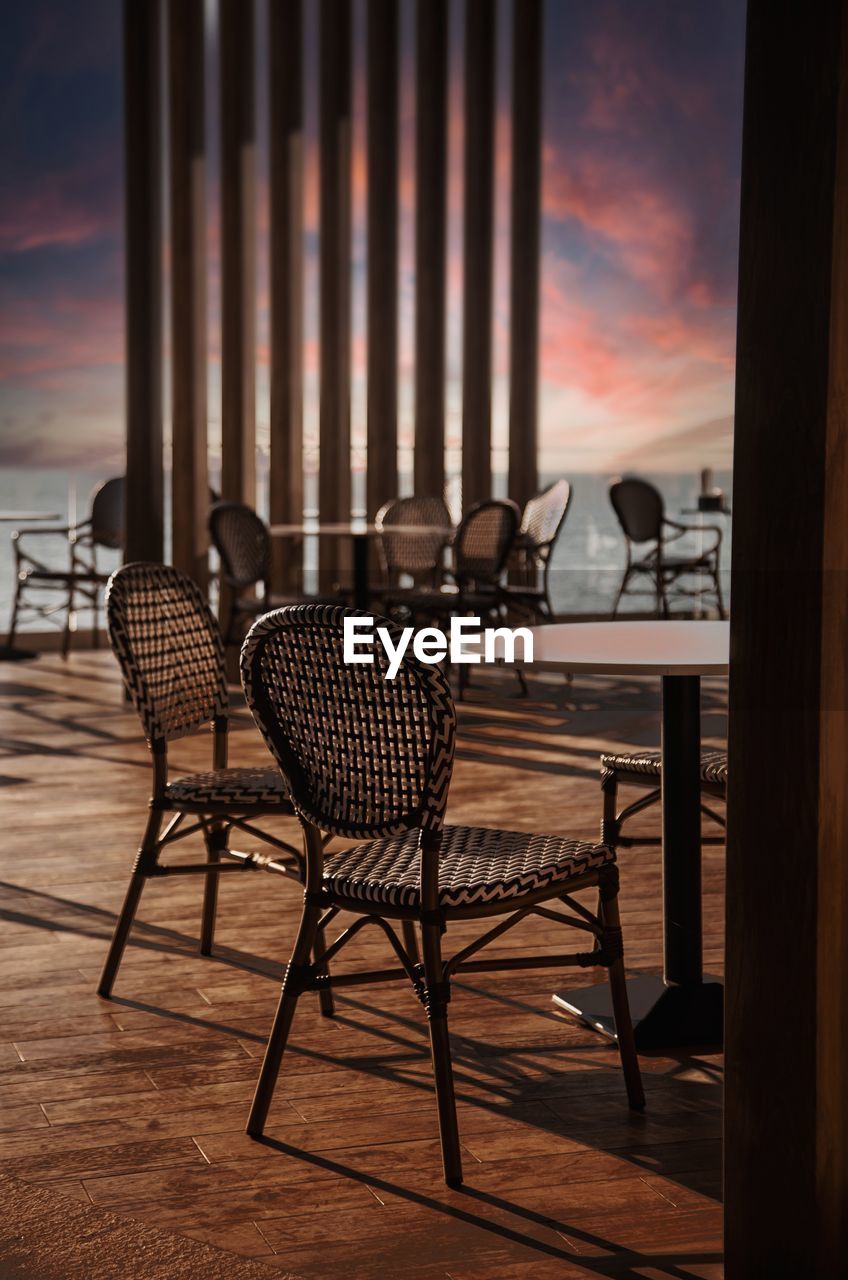 Empty chairs and tables at beach