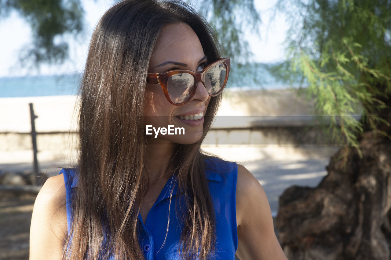 Portrait of young woman wearing sunglasses