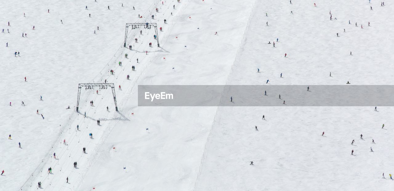 Aerial view of people on snowy landscape