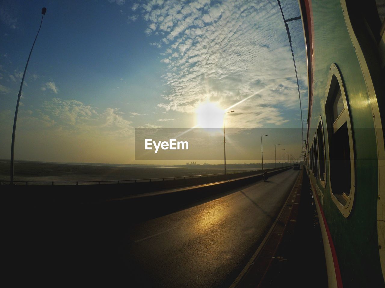 PANORAMIC SHOT OF TRAIN AGAINST SKY DURING SUNSET