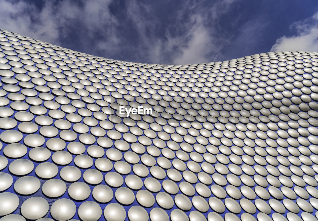 CLOSE-UP OF MODERN OFFICE BUILDING AGAINST SKY