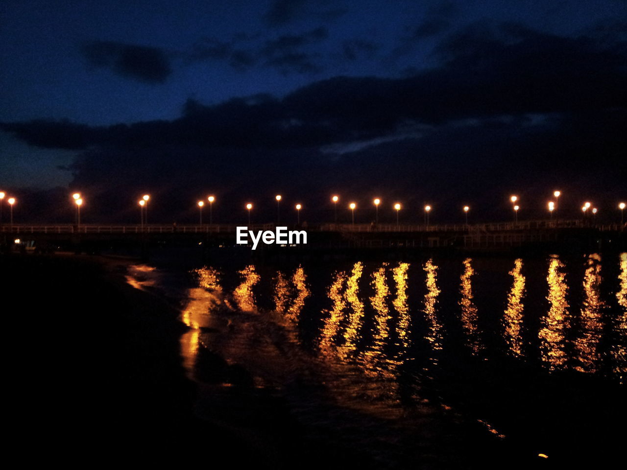 VIEW OF ILLUMINATED CITY AT NIGHT