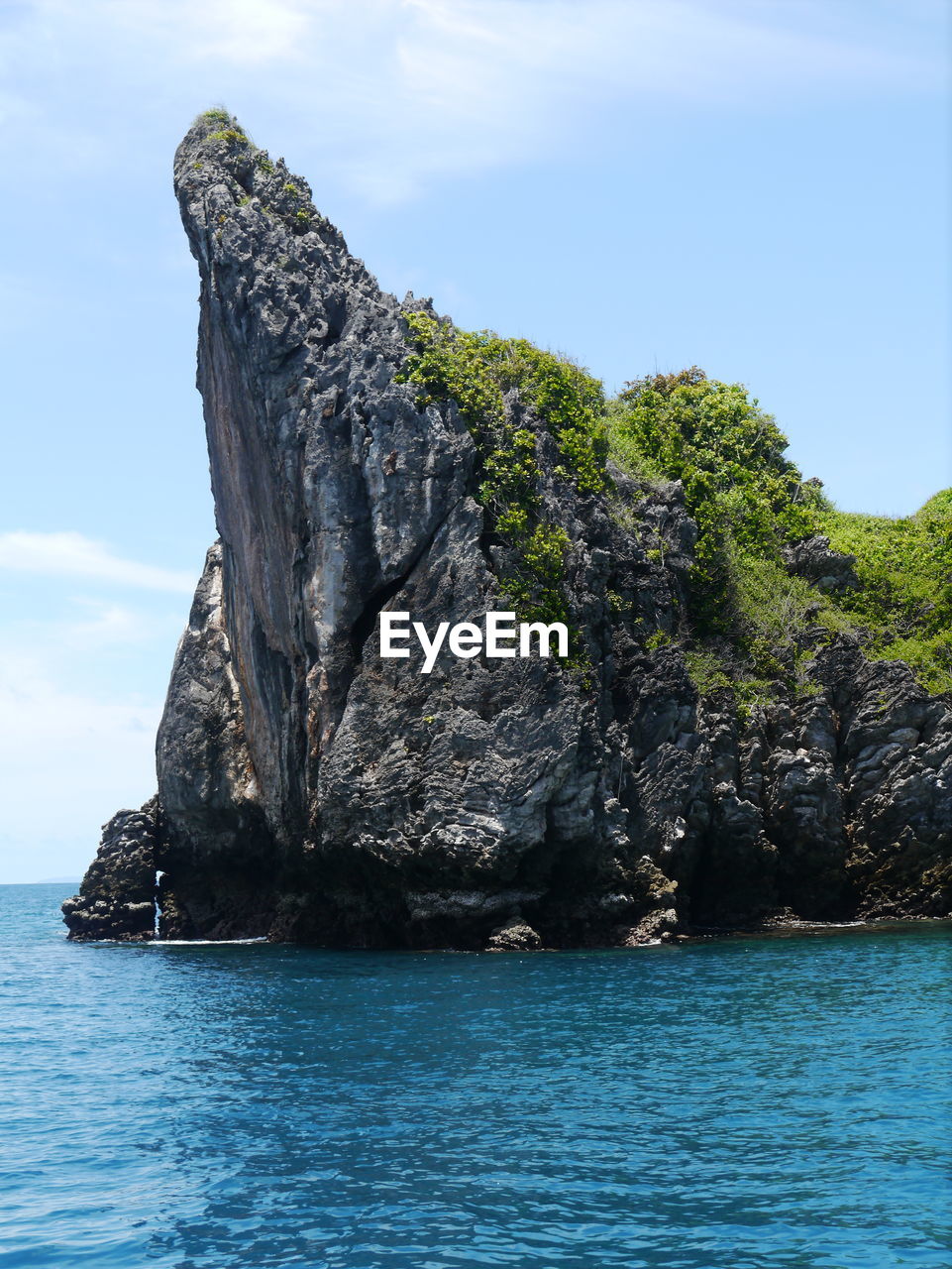 Rock formations in sea against sky