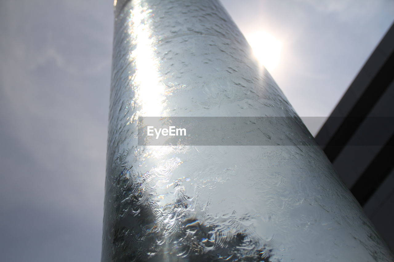 Low angle view of waterfall against sky