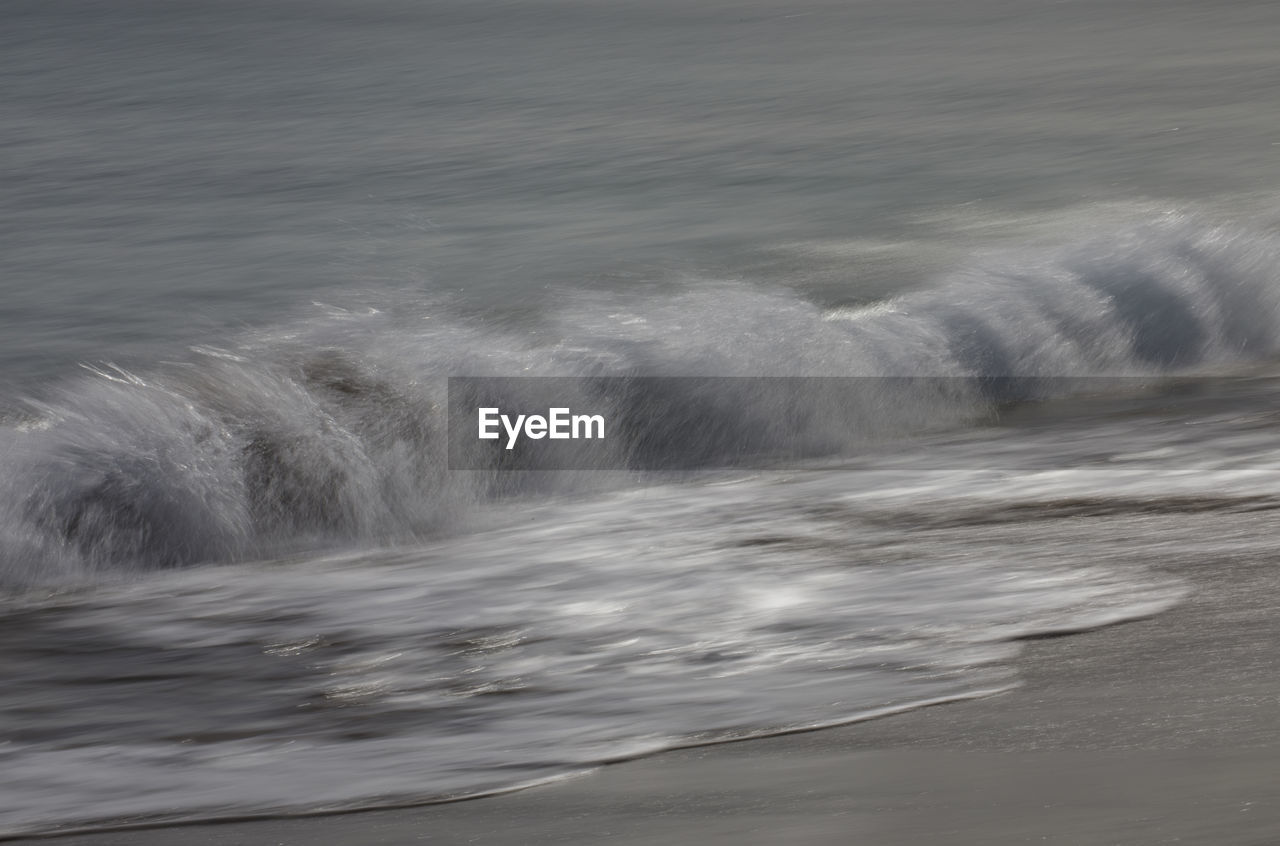 WAVES SPLASHING ON SHORE