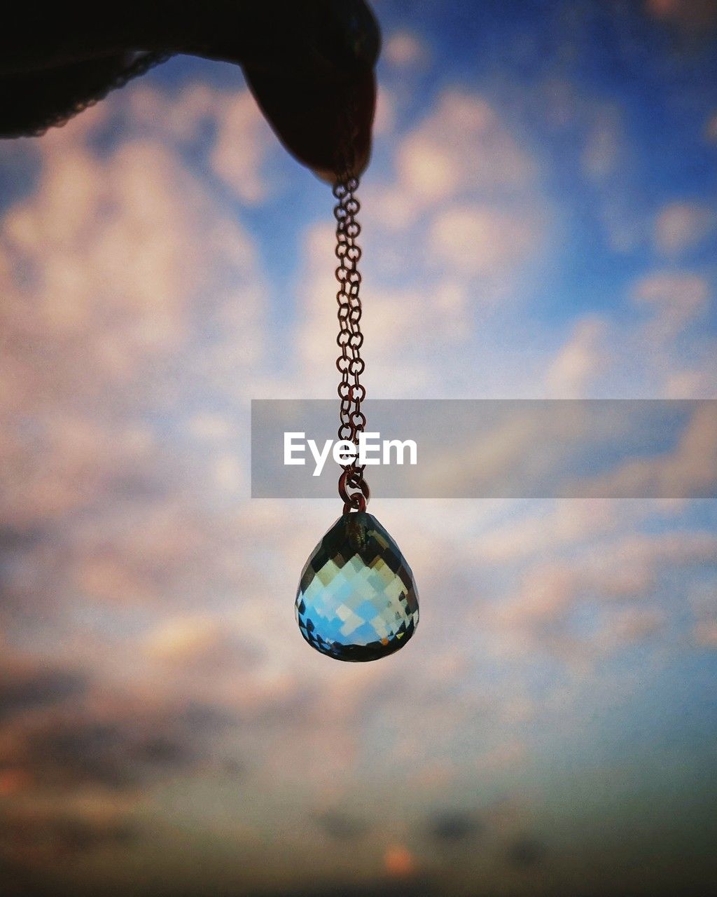 blue, reflection, hanging, cloud, sky, focus on foreground, macro photography, close-up, nature, no people, jewelry, water, fashion accessory, light, single object, sphere, outdoors, jewellery, shiny