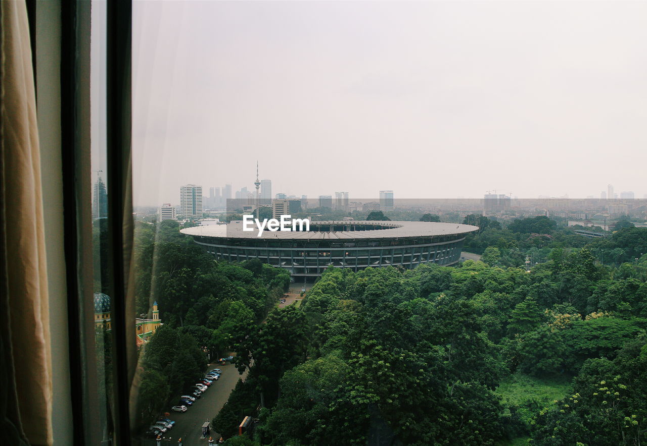 Stadium seen through window against clear sky