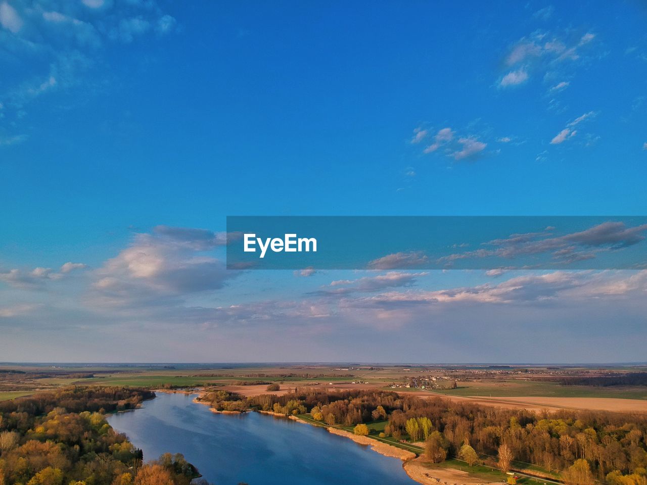 Scenic view of landscape against blue sky