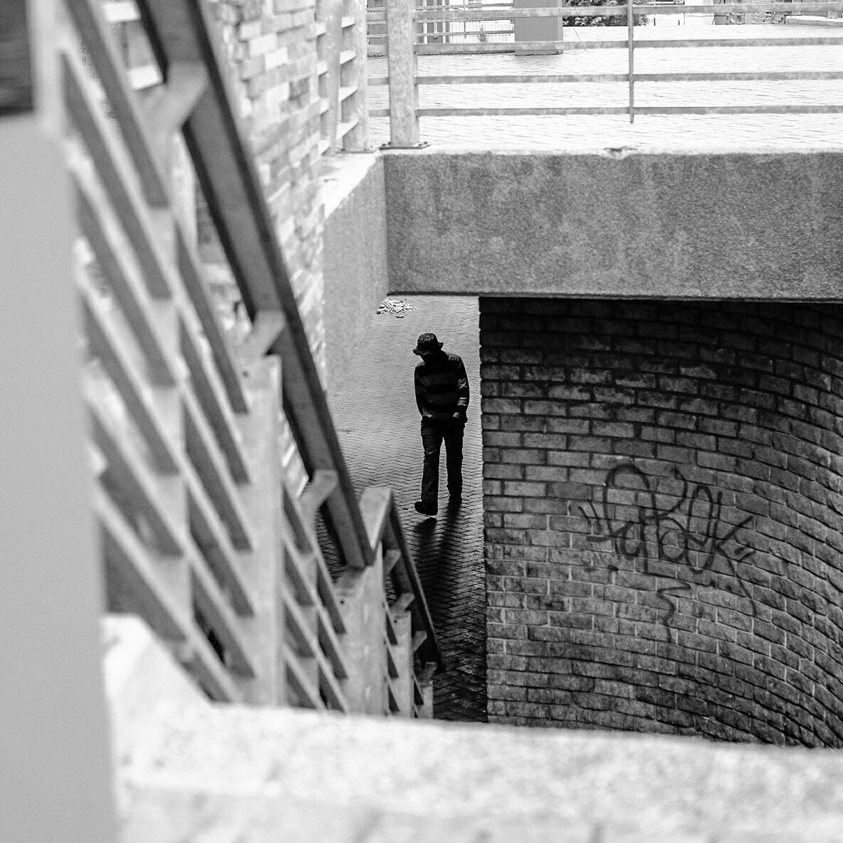 High angle view of man walking on footpath