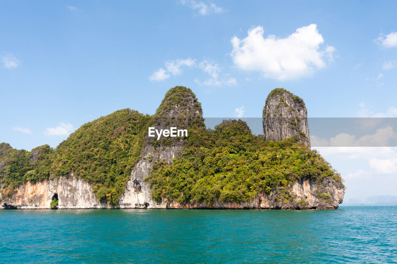 Scenic view of rocks in sea against sky