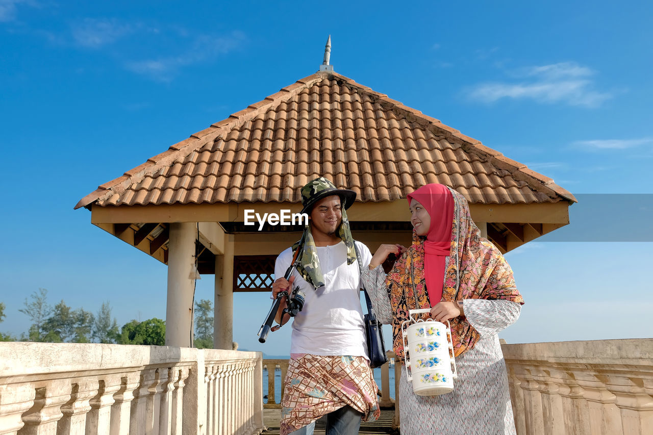 Couple walking on footbridge