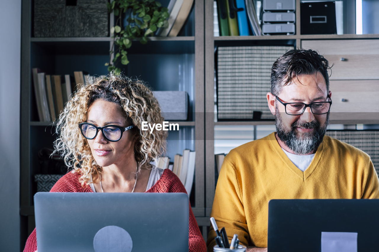 Business people looking at computer in office