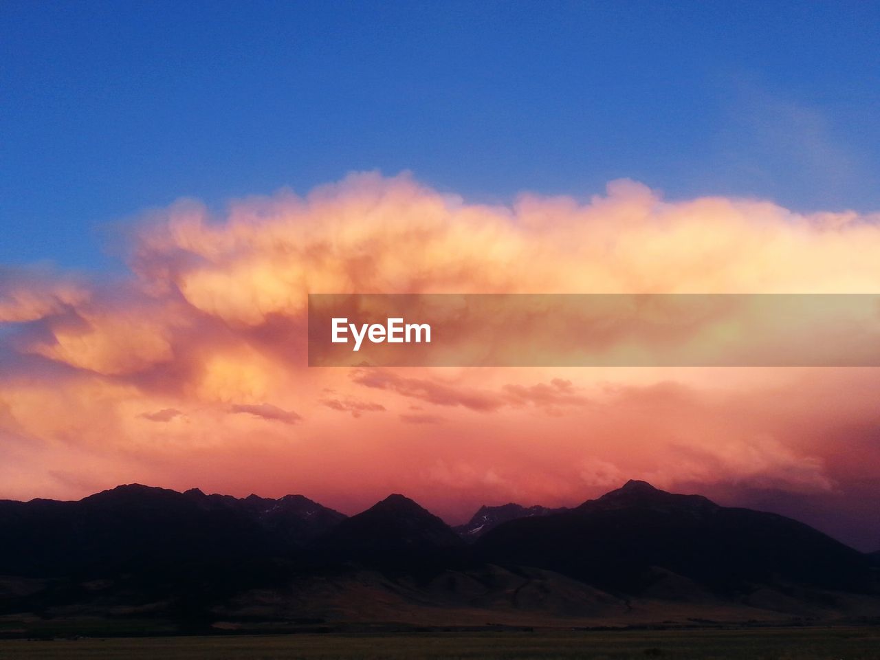 SCENIC VIEW OF MOUNTAINS AT SUNSET