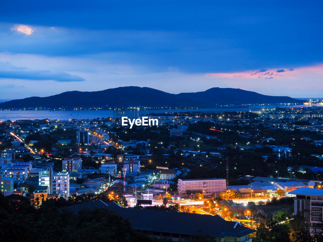 High angle view of illuminated city against sky at night