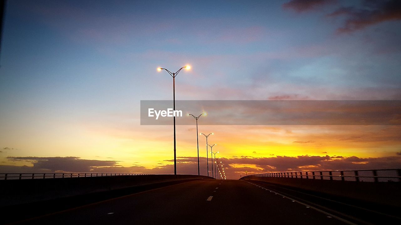 STREET LIGHT AGAINST SKY AT SUNSET