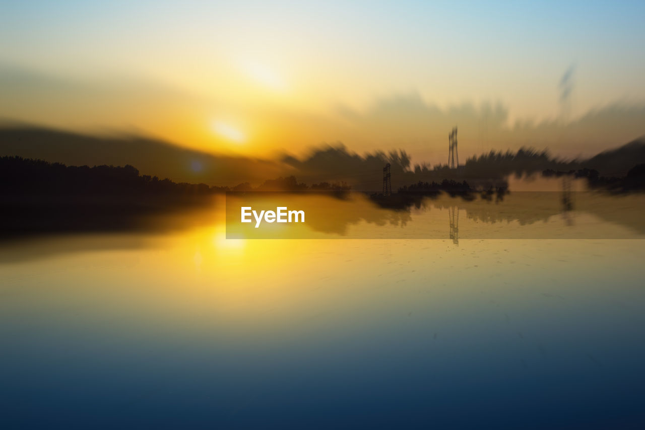 SCENIC VIEW OF SUNSET OVER LAKE