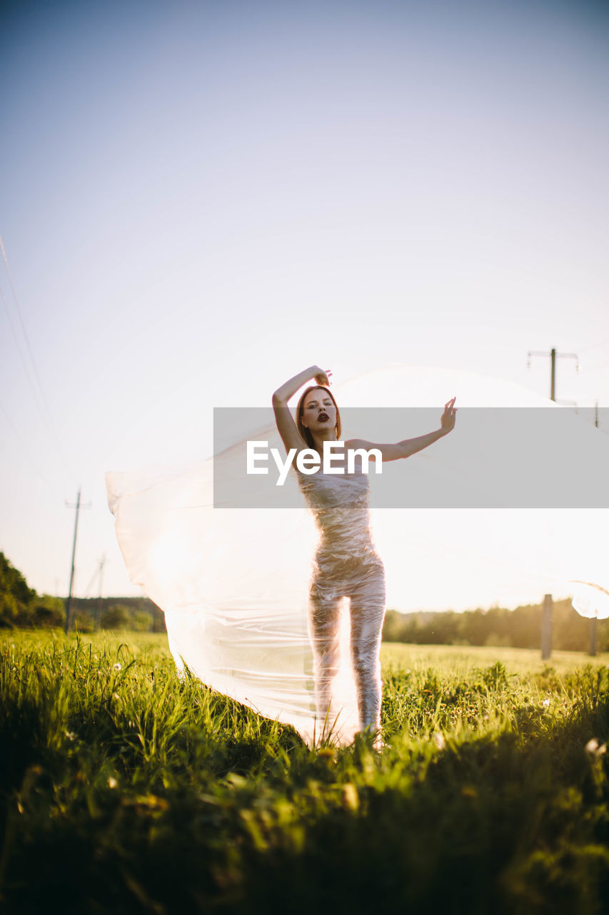 Full length of woman on field against sky