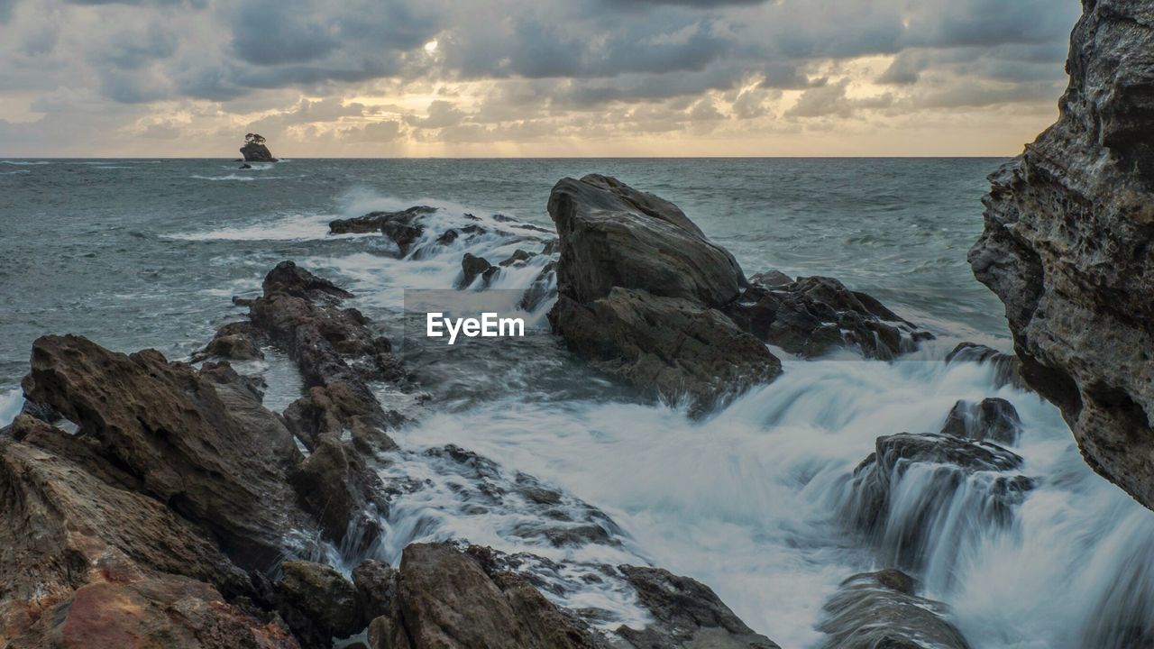 SCENIC VIEW OF SEA AND ROCKS AGAINST SKY